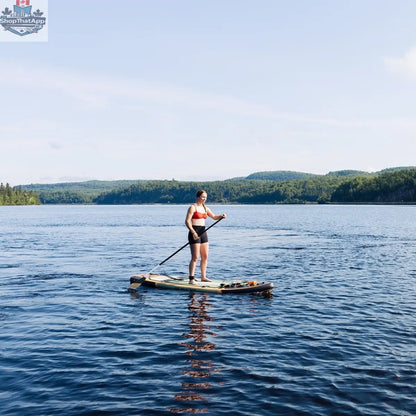 Green Sequoia XL inflatable paddleboard by The Wild Tribe, 11-foot lightweight and durable stand-up paddleboard on water.