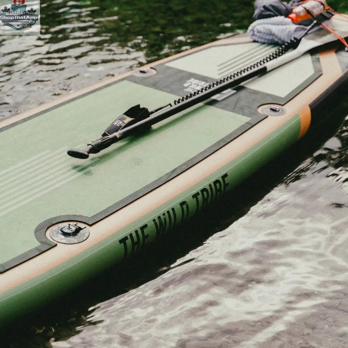 Green Sequoia XL inflatable paddleboard by The Wild Tribe, 11-foot lightweight and durable stand-up paddleboard on water.
