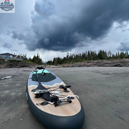 Inflatable Peyto 11' paddleboard by The Wild Tribe, shown on water, with paddle and carrying bag for outdoor water sports.