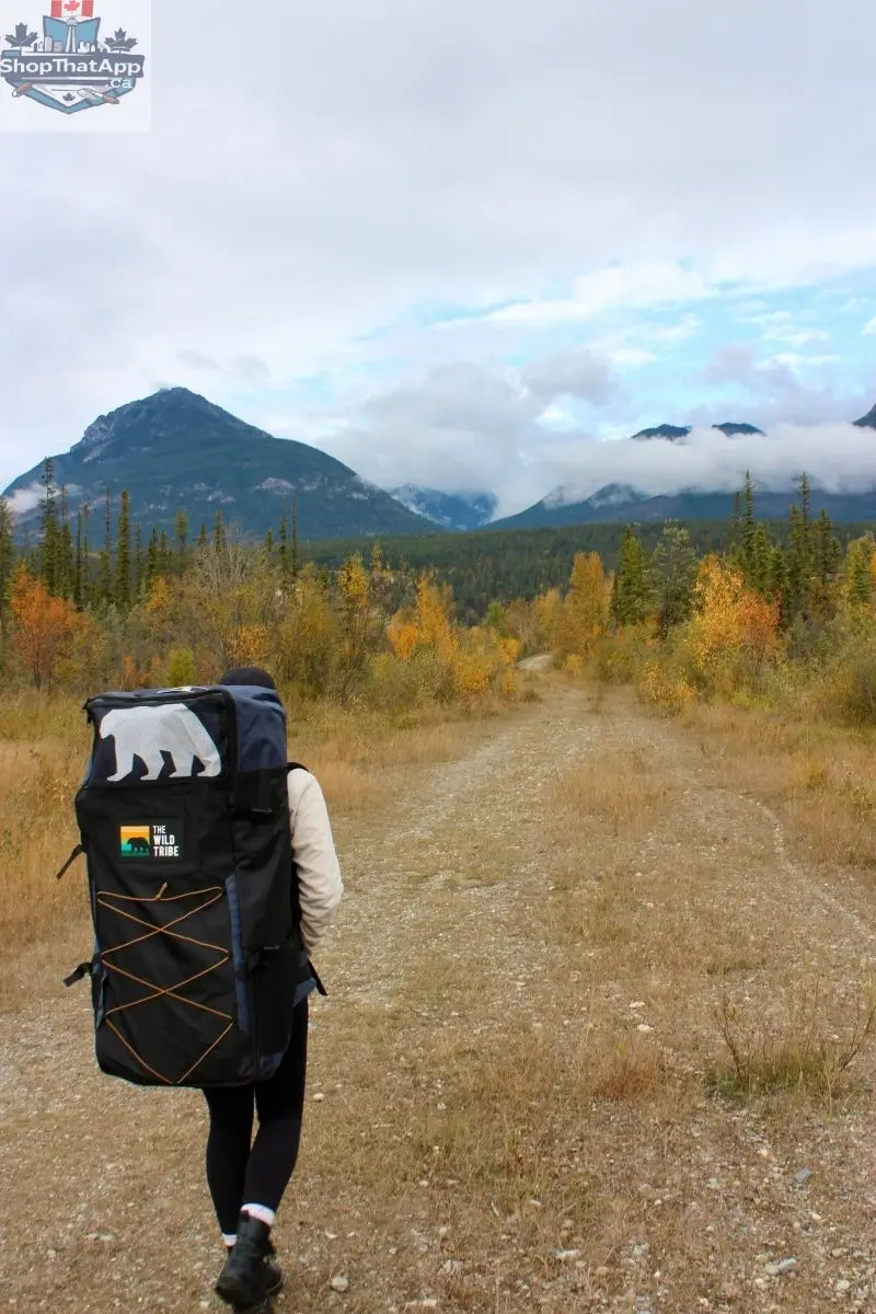 Golden Peyto 11' inflatable paddleboard by The Wild Tribe, designed for all-around water adventures, shown on calm water.
