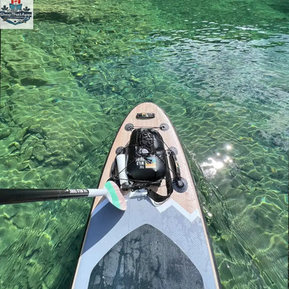 Inflatable Peyto 11' paddleboard by The Wild Tribe, shown on water with paddle and gear for outdoor paddling adventures.