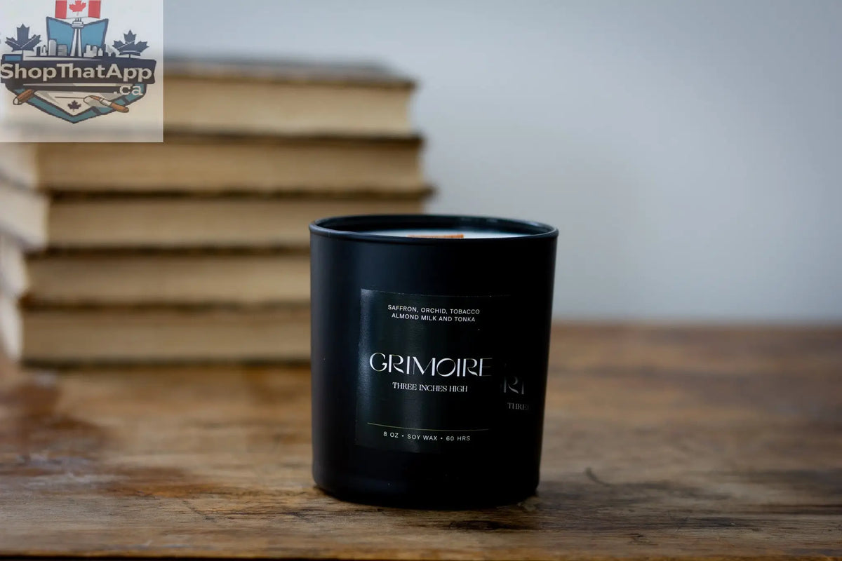 8oz soy wax Grimoire Candle by Three Inches High, featuring a mystical book design and warm candle flame.