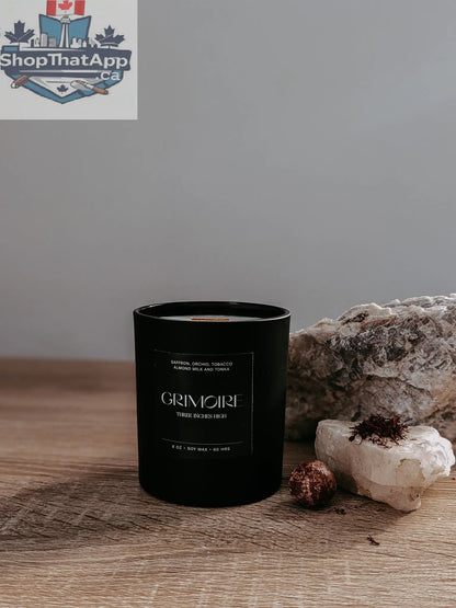 8oz soy wax Grimoire Candle by Three Inches High featuring a mystical book design and warm candle flame.