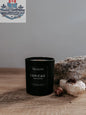 8oz soy wax Grimoire Candle by Three Inches High featuring a mystical book design and warm candle flame.