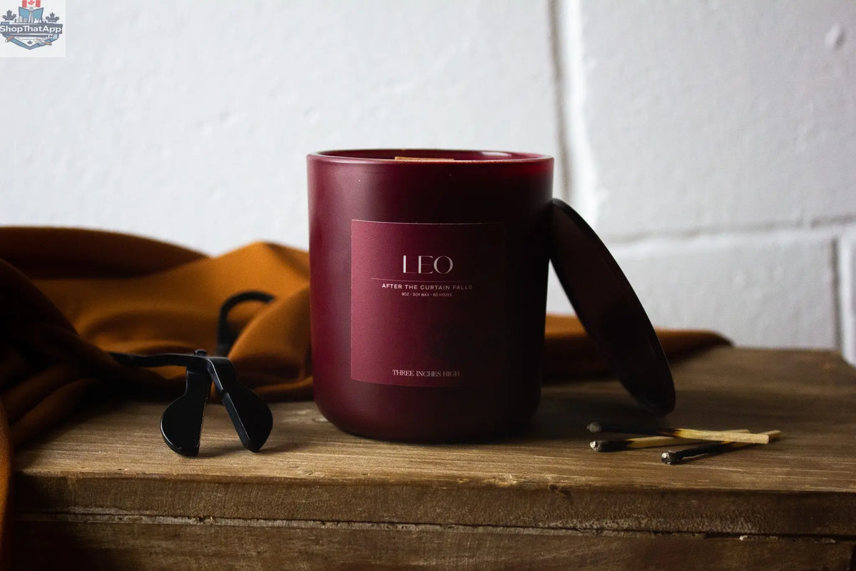 Leo soy candle by Three Inches High in an 8oz all-natural soy wax container, with a lit wick and a warm, inviting glow.