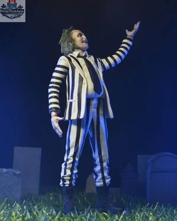 Beetlejuice action figure in black and white suit, Toy Snowman collectible toy, detailed figure with spooky character features.