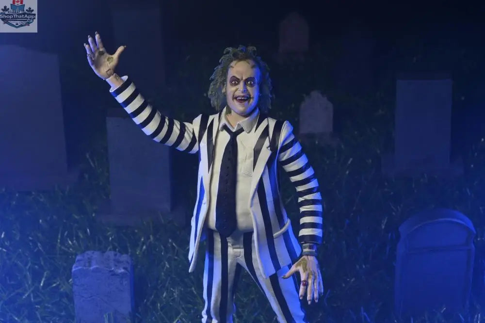 Beetlejuice action figure in black and white suit, Toy Snowman collectible toy, detailed figure pose with spooky character design.