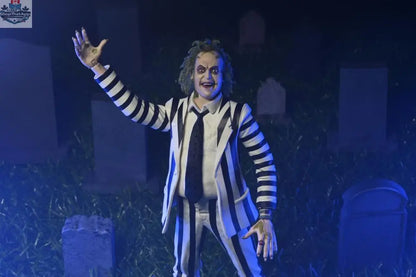 Beetlejuice action figure in black and white suit, Toy Snowman collectible toy, detailed figure pose with spooky character design.