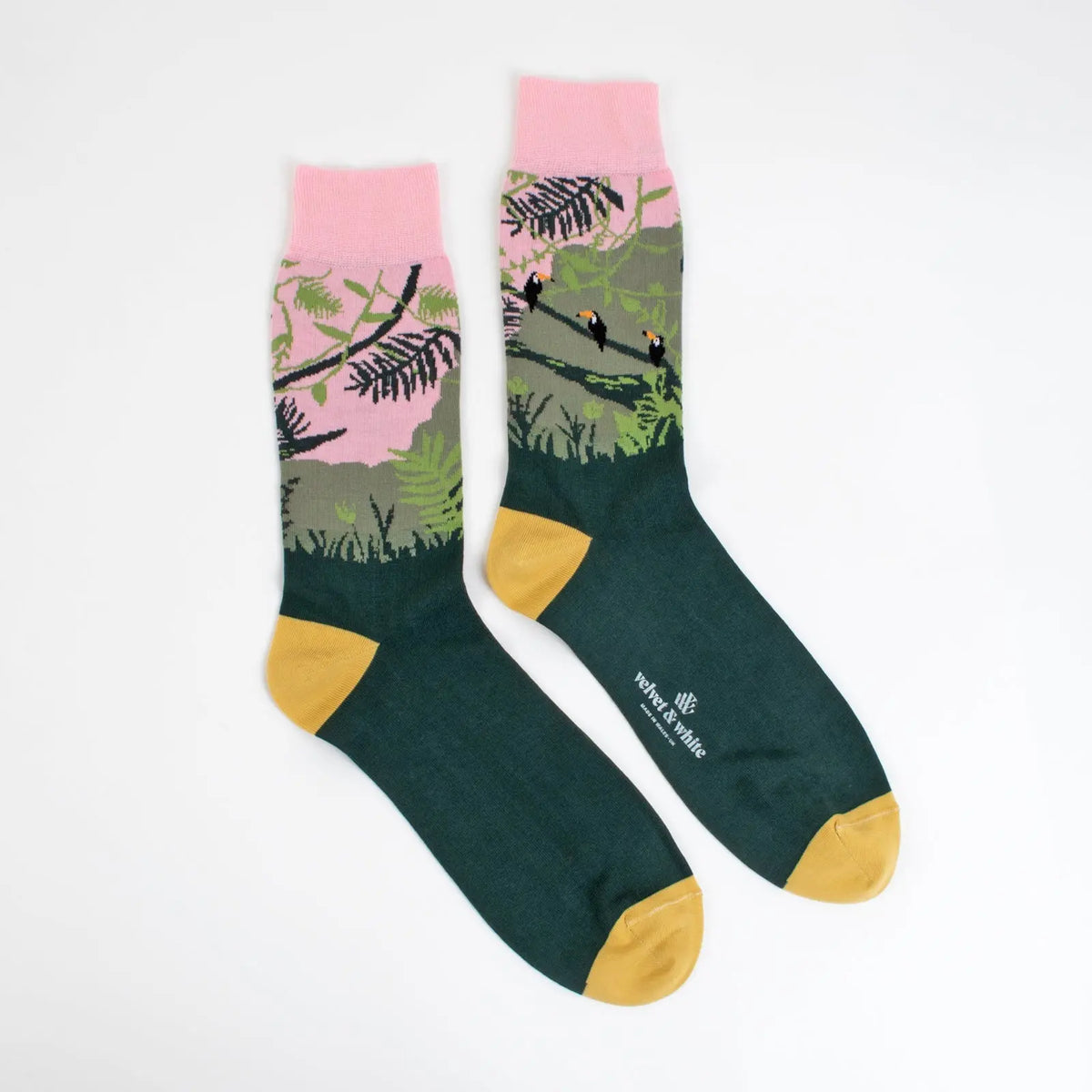 Green and pink safari-themed socks by Velvet and White, featuring playful animal designs for stylish children's rooms.