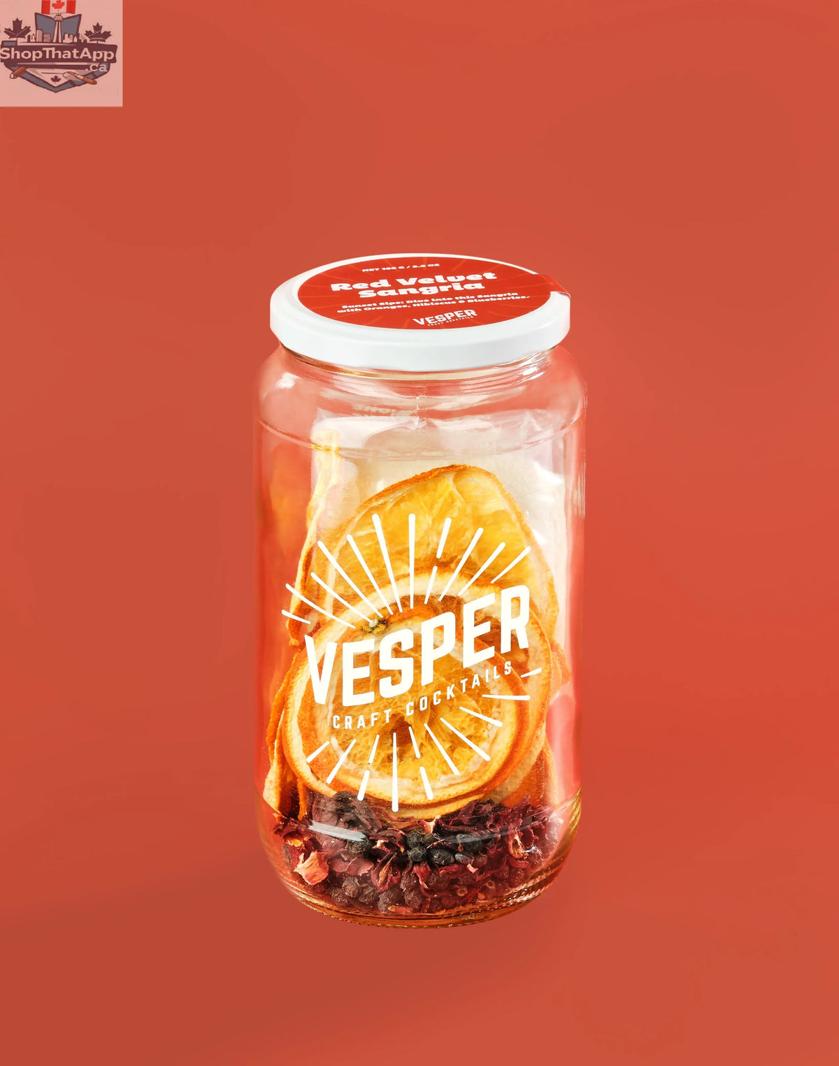 Glass of vibrant red velvet sangria with fresh fruit, showcasing Vesper Cocktails' festive red wine recipe in a clear glass.
