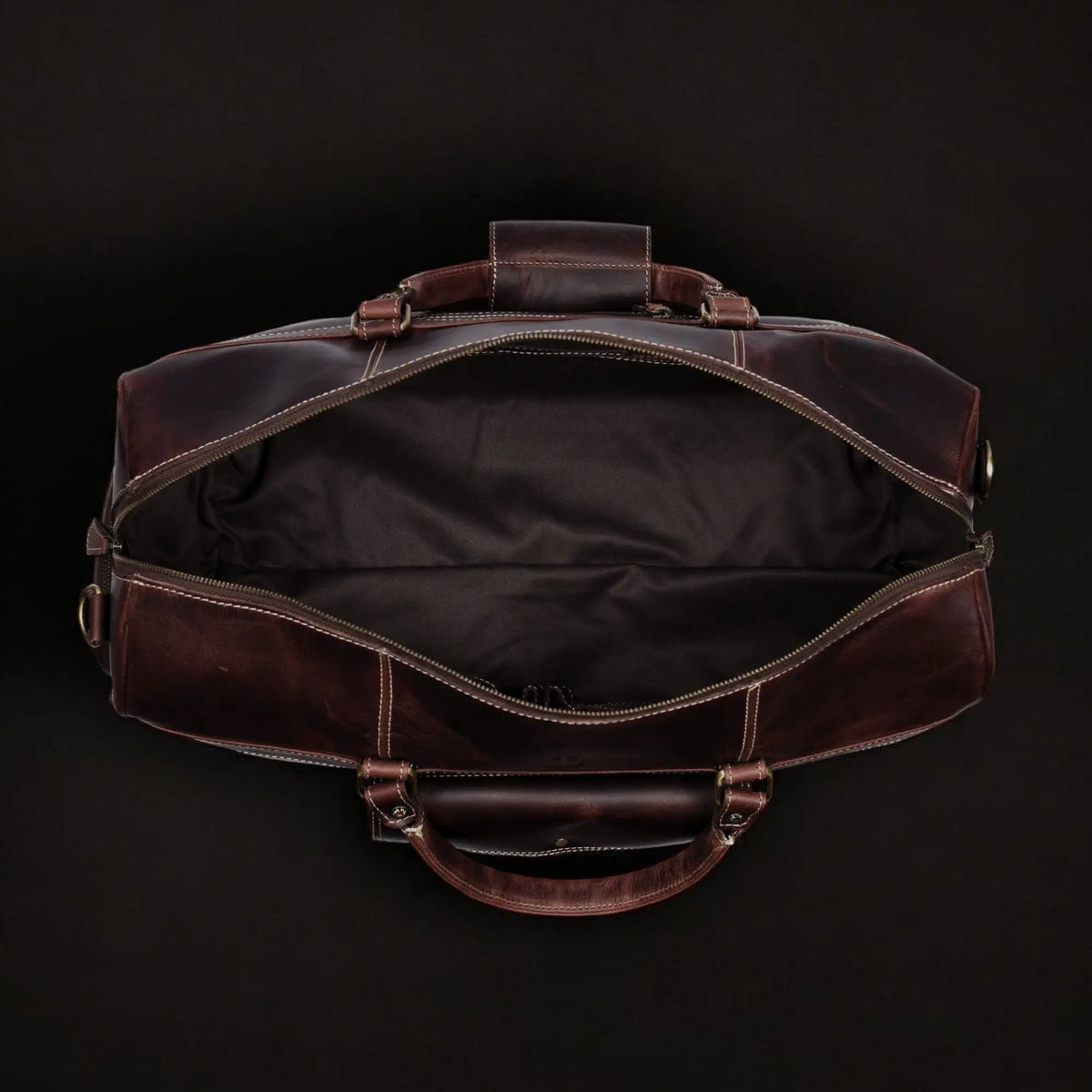 Brown full-grain distressed leather Voyager Duffle bag by NAB Leather, showing sturdy handles and spacious design.
