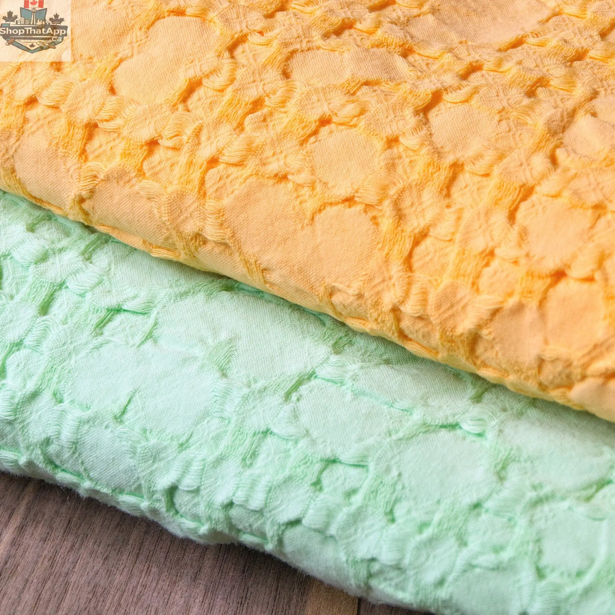 Close-up of Hem and Tassel Box Waffle Cotton Throw in mango and pistachio, showcasing its soft, textured fabric and wearable design.