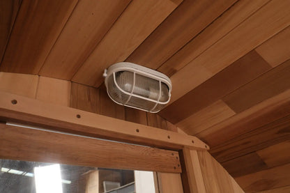 Zoppinh Blisspod Canadian Red Cedar outdoor sauna with full glass back and two front porch seats, designed for 2-6 persons.