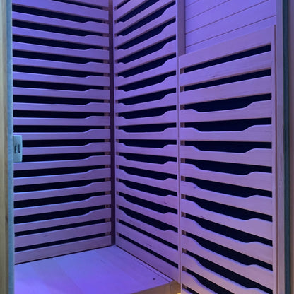 Zoppinh Blisspod Helsinki indoor sauna for two with full spectrum lighting and red light therapy, featuring wooden interior and control panel.